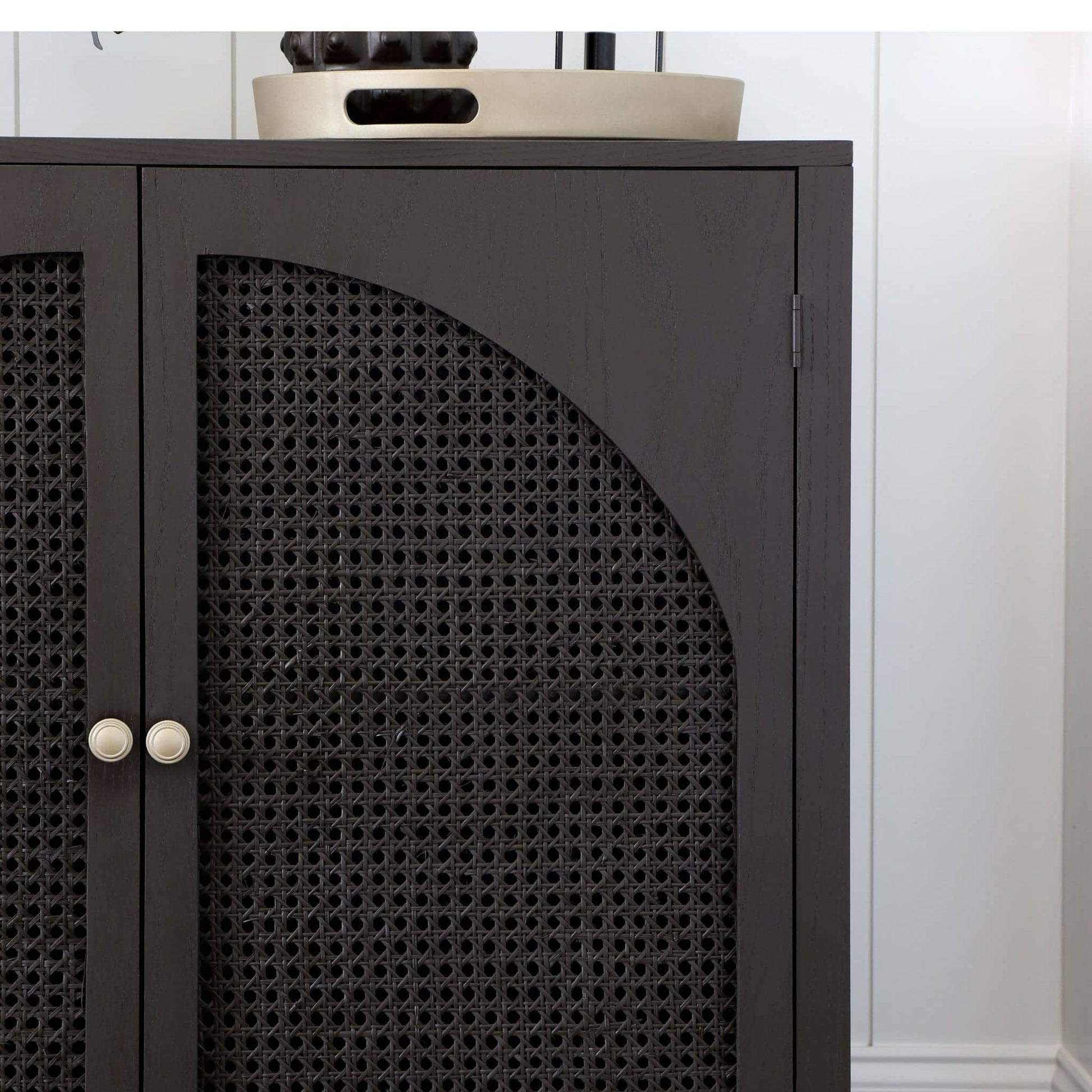 close up of DIY accent cabinet with arched cane doors