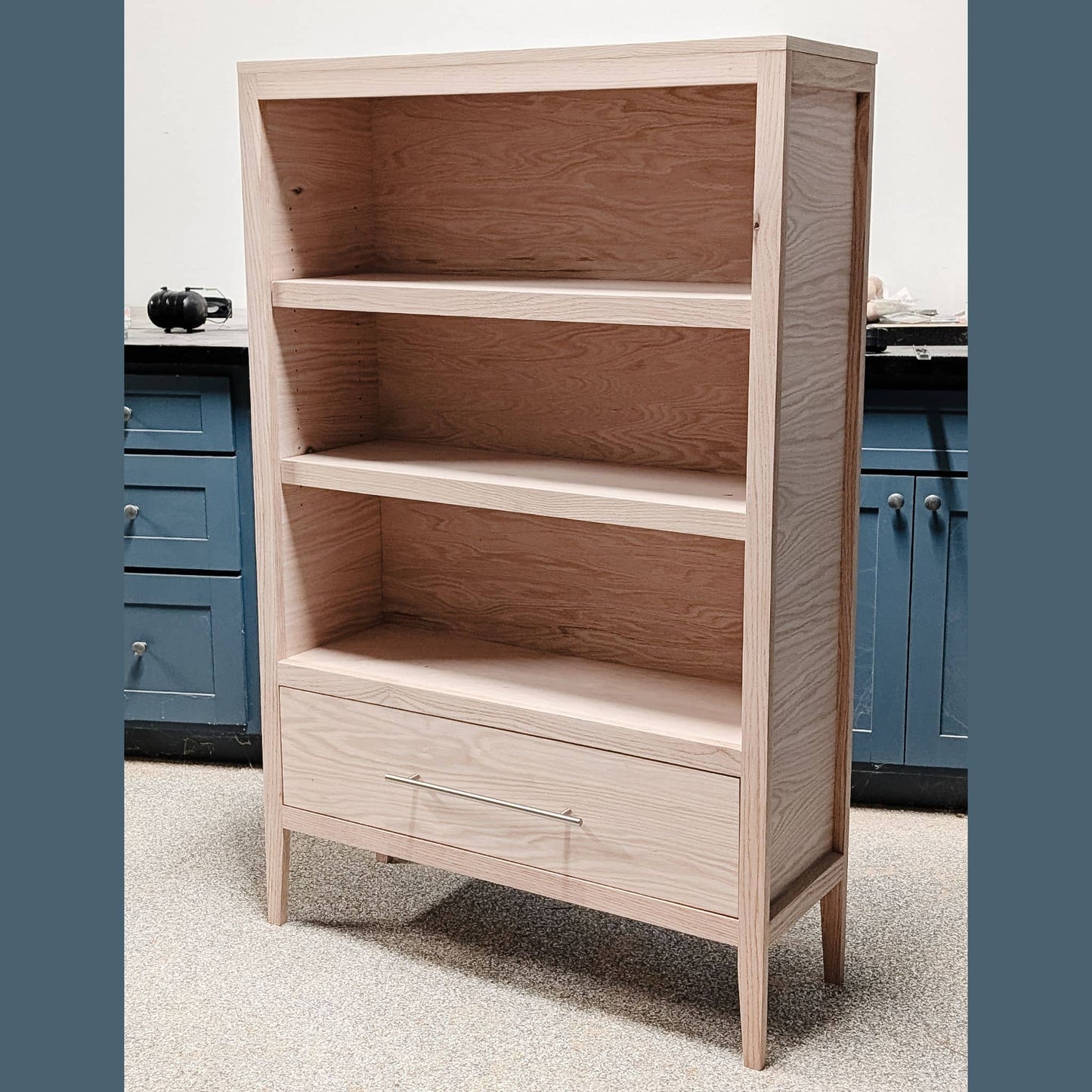 DIY bookcase with 3 shelves and drawer in garage workshop