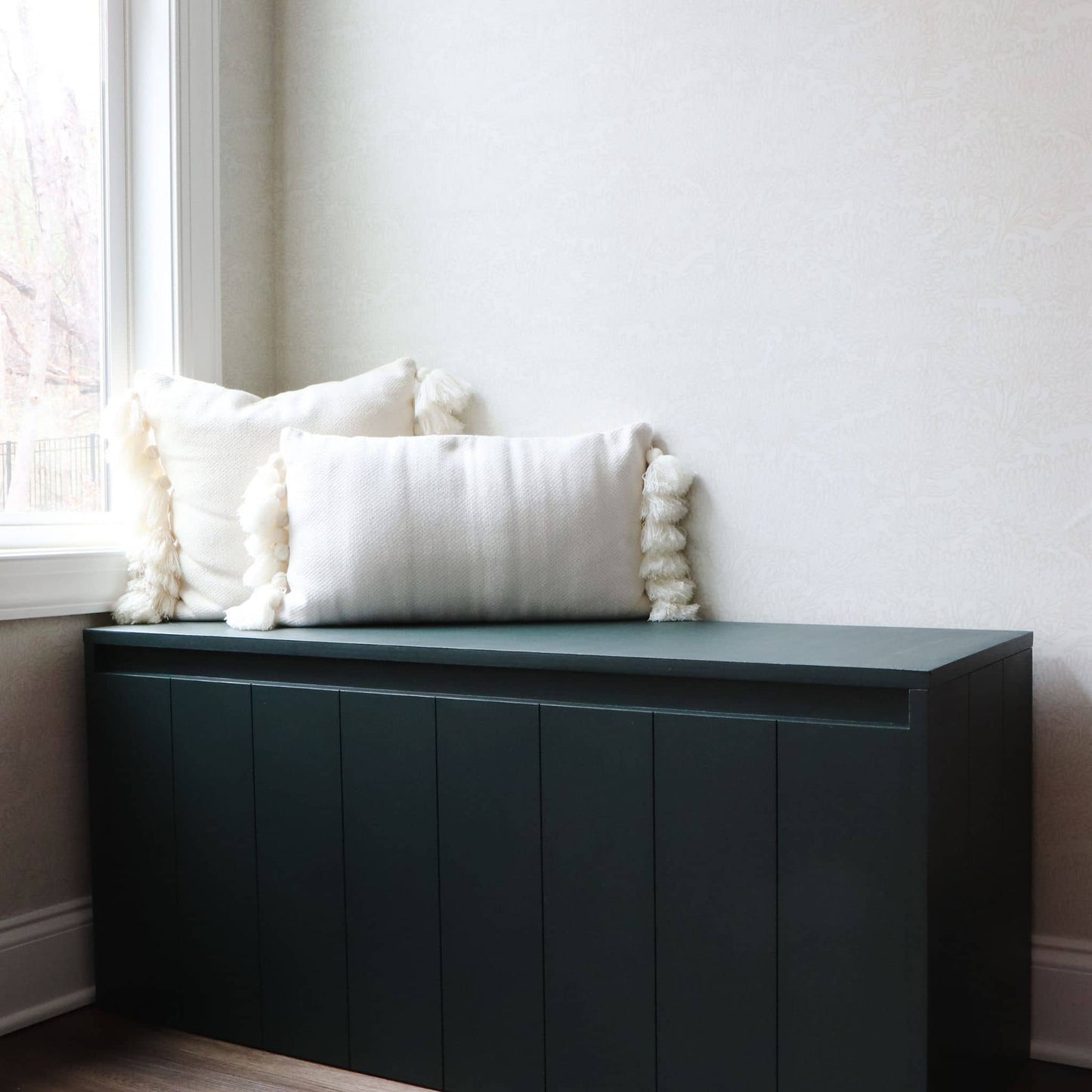 DIY storage bench in corner next to big window