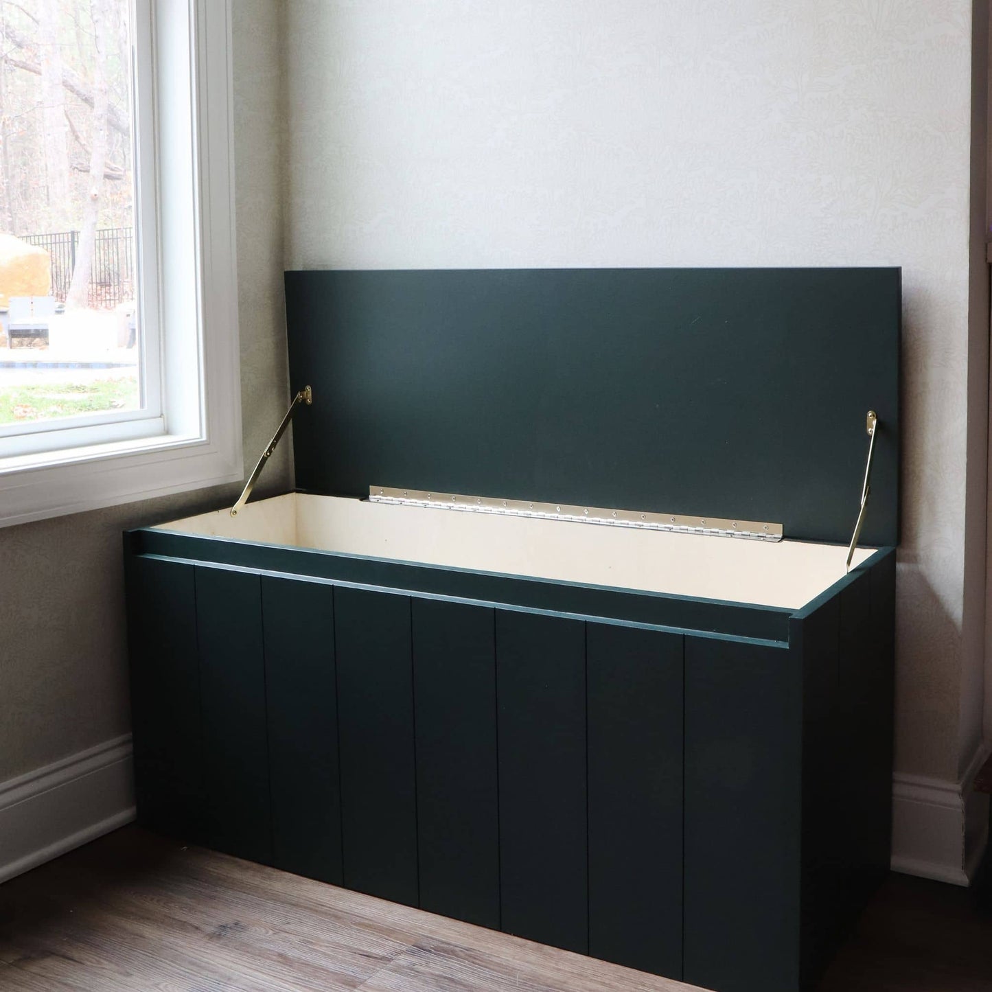 DIY storage bench with top lifted open to reveal storage inside