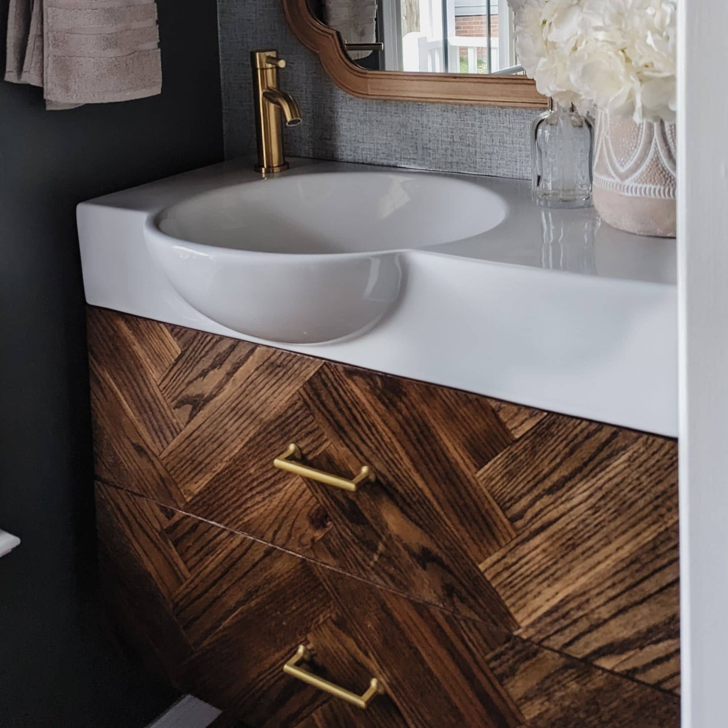 Floating Vanity stained with gold handles in a bathroom