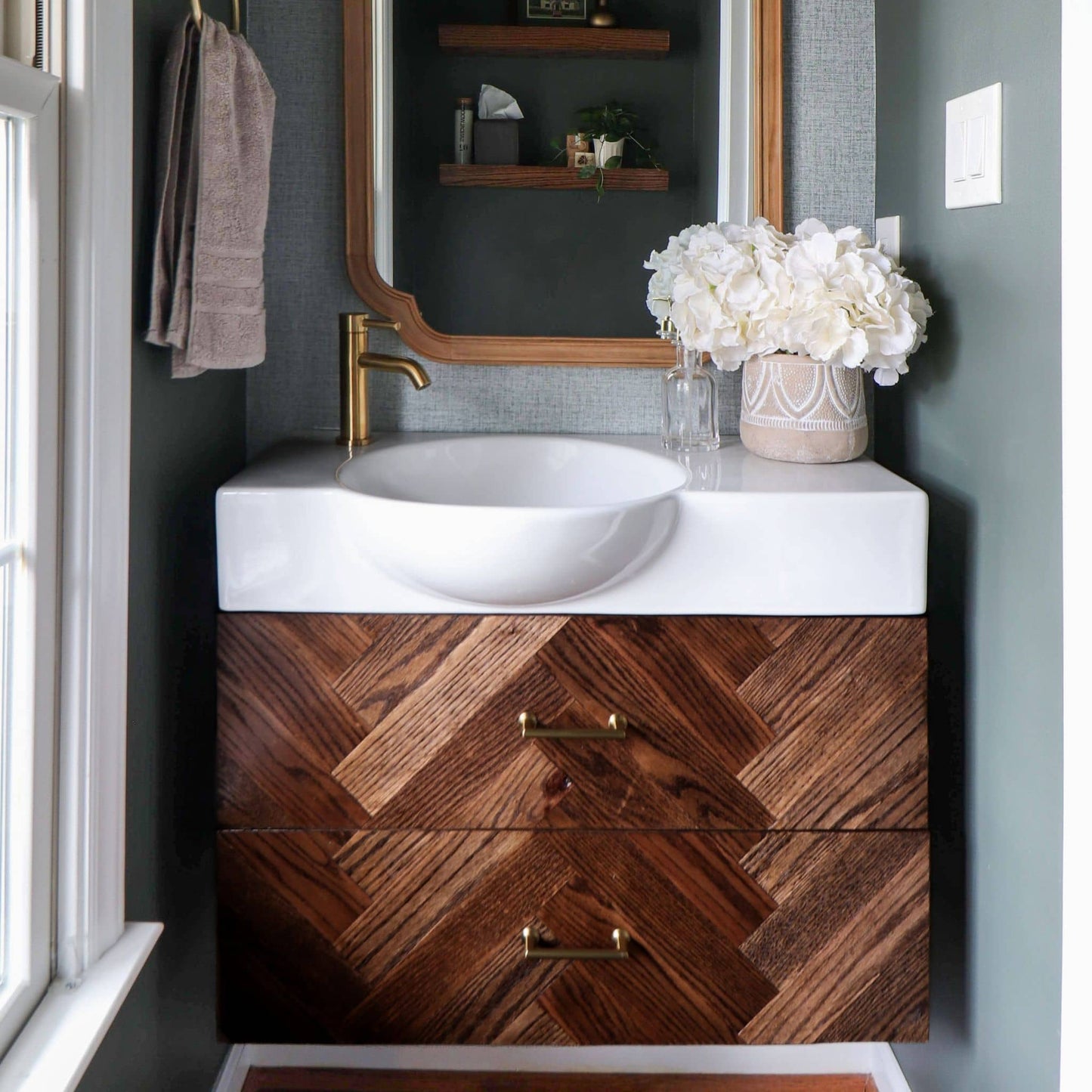 Floating Vanity stained with gold accents in a bathroom