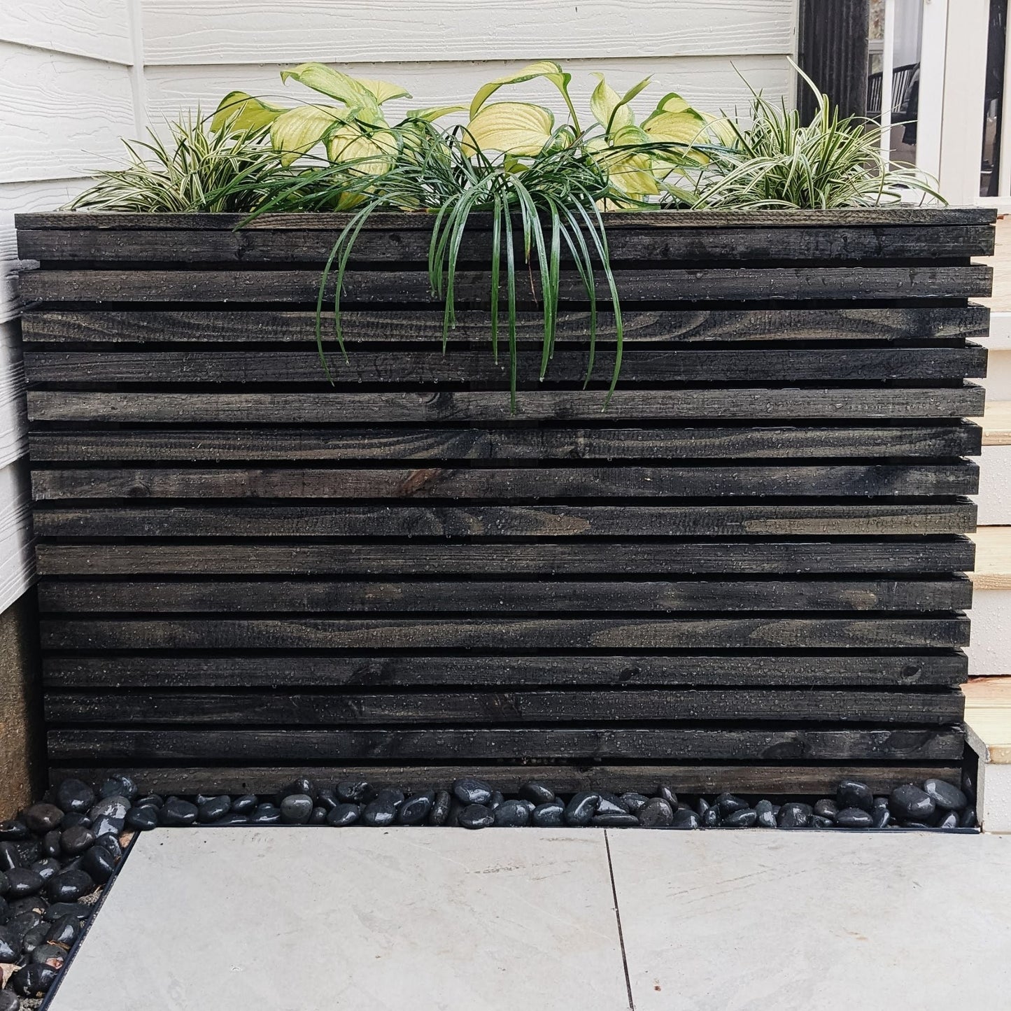 Large Slatted Planter stained black with plants inside