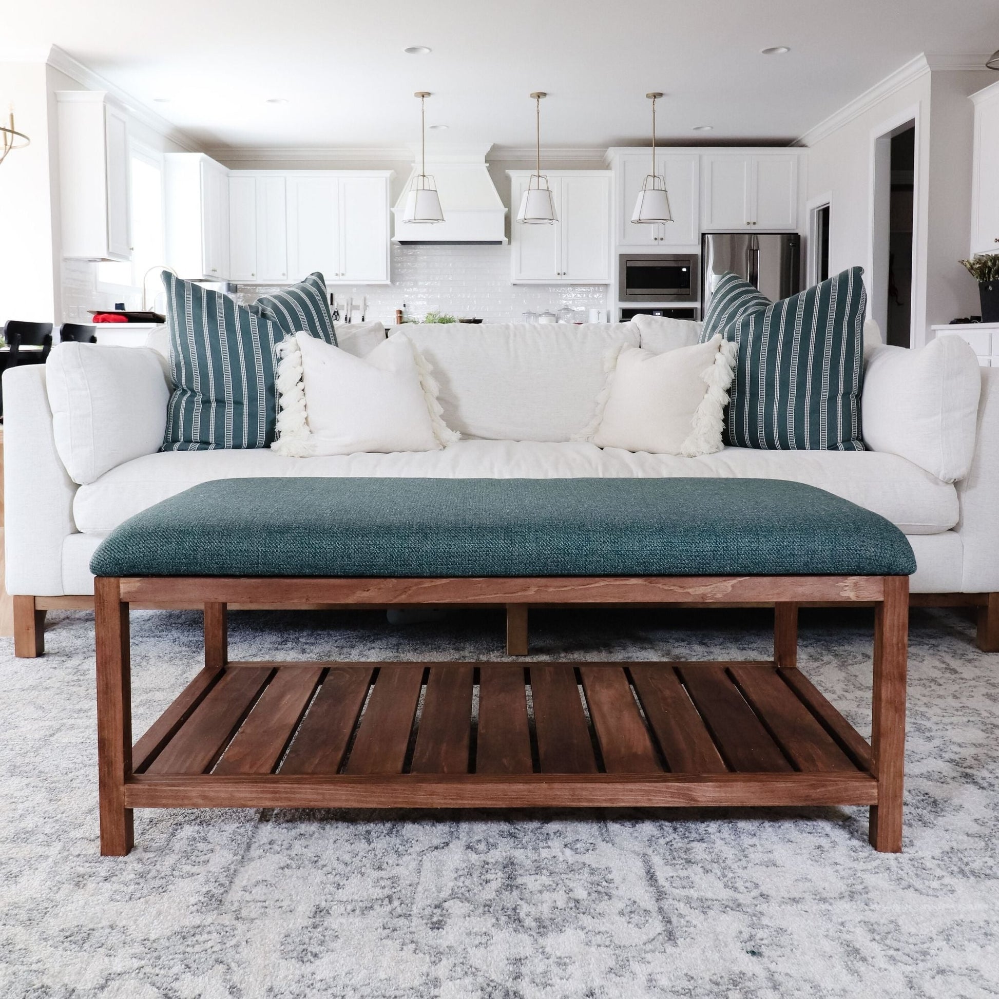 Ottoman Coffee Table with green upholstered top in a living room