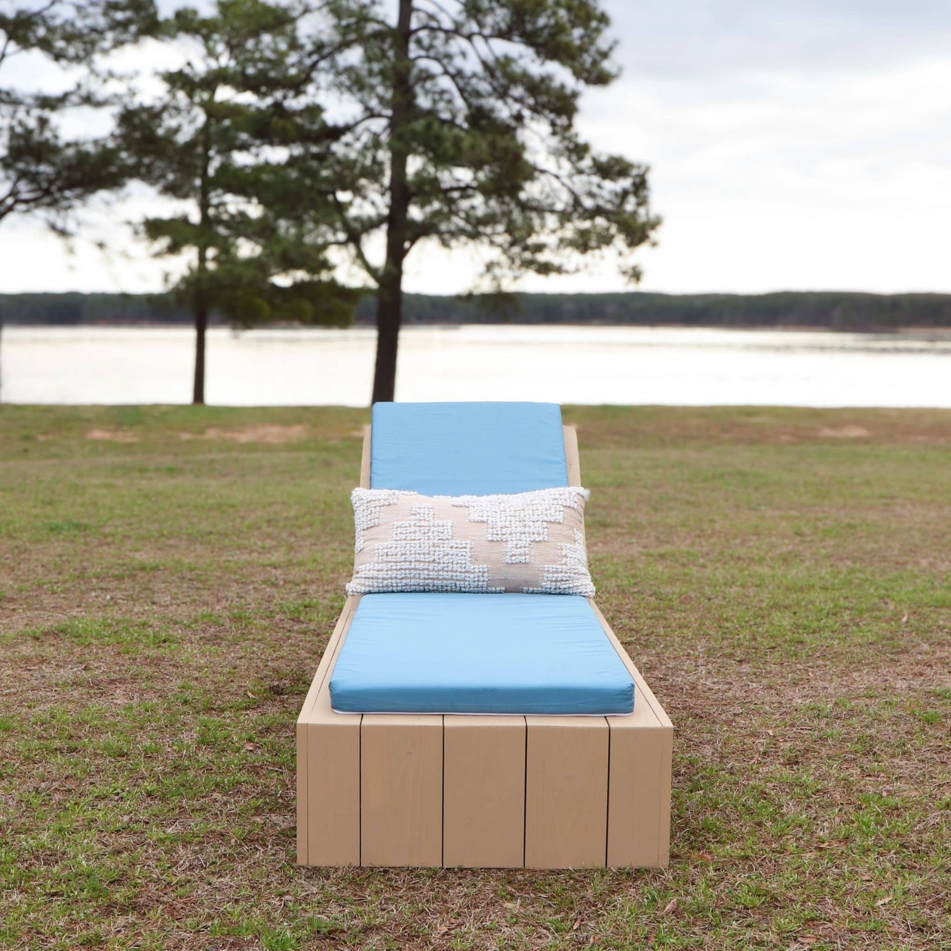 Outdoor Lounge Chair with Adjustable Back styled with a blue lounge cushion and decorative pillow