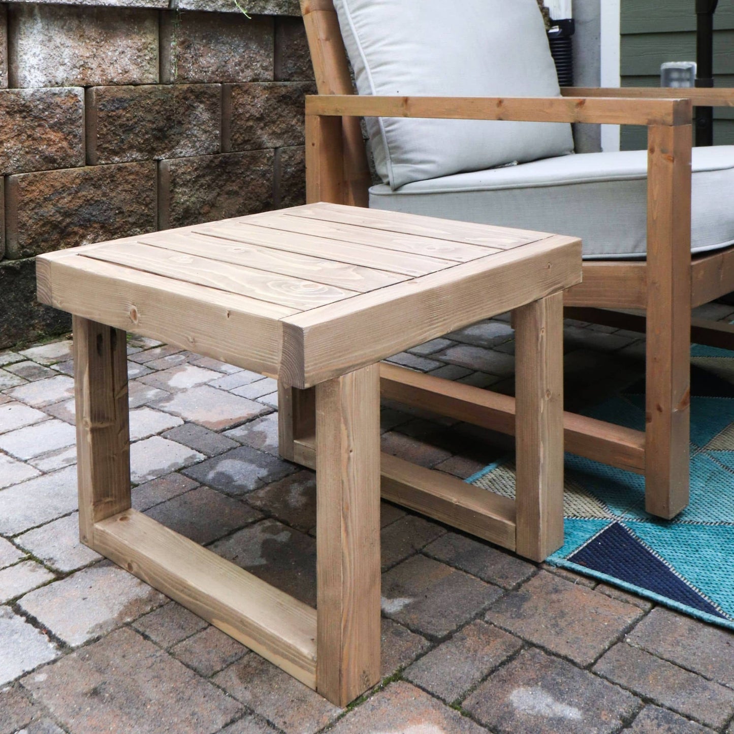 Outdoor Side Table on a brick patio next to an outdoor chair