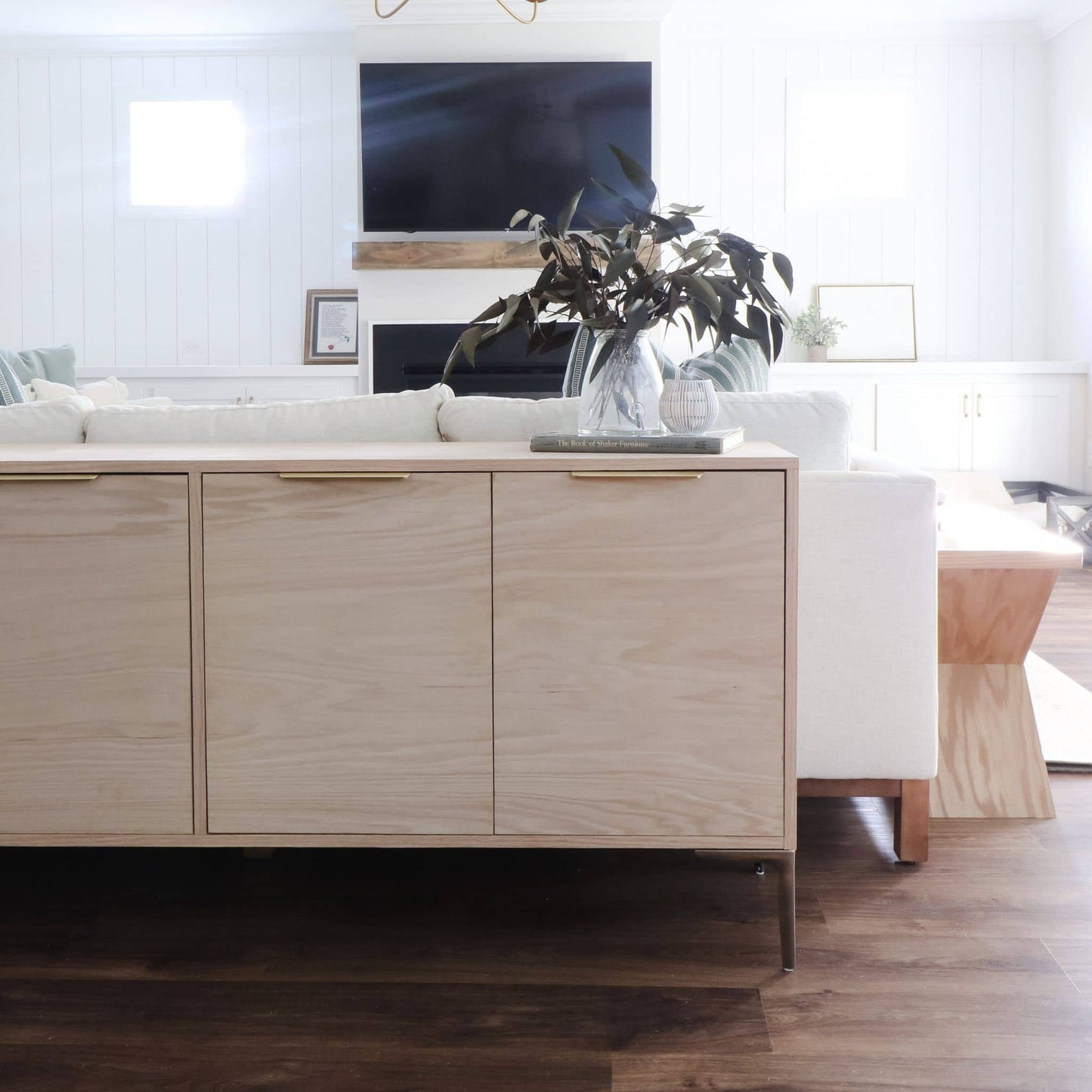 Sideboard decorated behind a couch