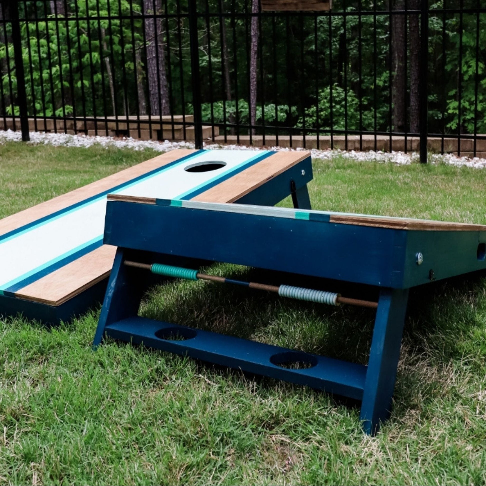 The Ultimate Cornhole Boards with blue, aqua, and white stripe